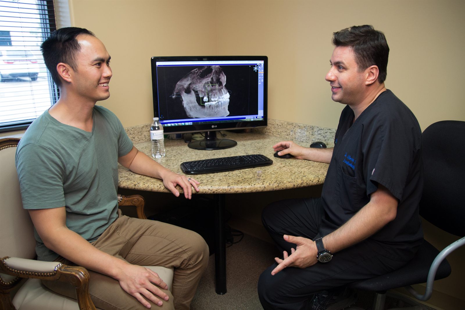 Dr. Saba reviewing a patient's 3D scan with them on screen